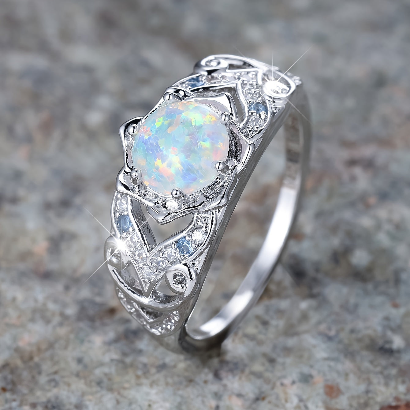 A delicate silver ring with synthetic opal and sapphire trim - perfect for parties and weddings