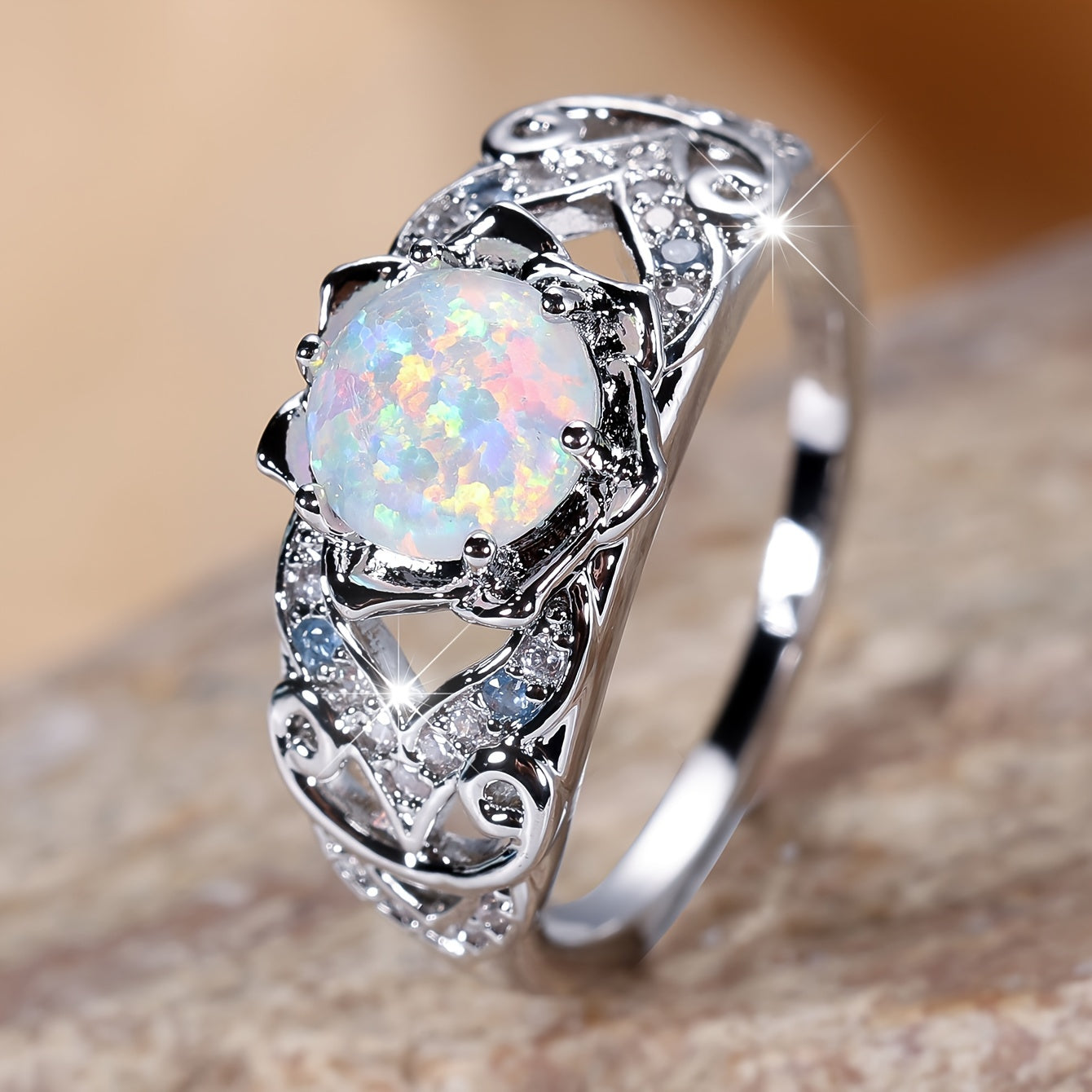 A delicate silver ring with synthetic opal and sapphire trim - perfect for parties and weddings