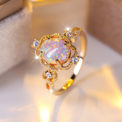 An elegant bohemian-style copper engagement ring with white synthetic opal and cubic Zirconia trim and gold-plated jewelry for weddings and parties