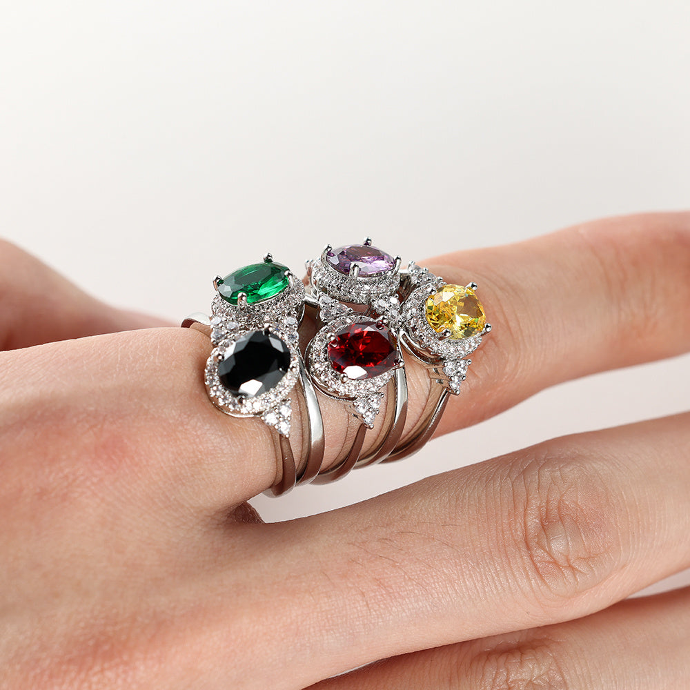 The elegant claw ring is suitable for women and is set with oval gemstones in silver, black, yellow, green, red and purple.