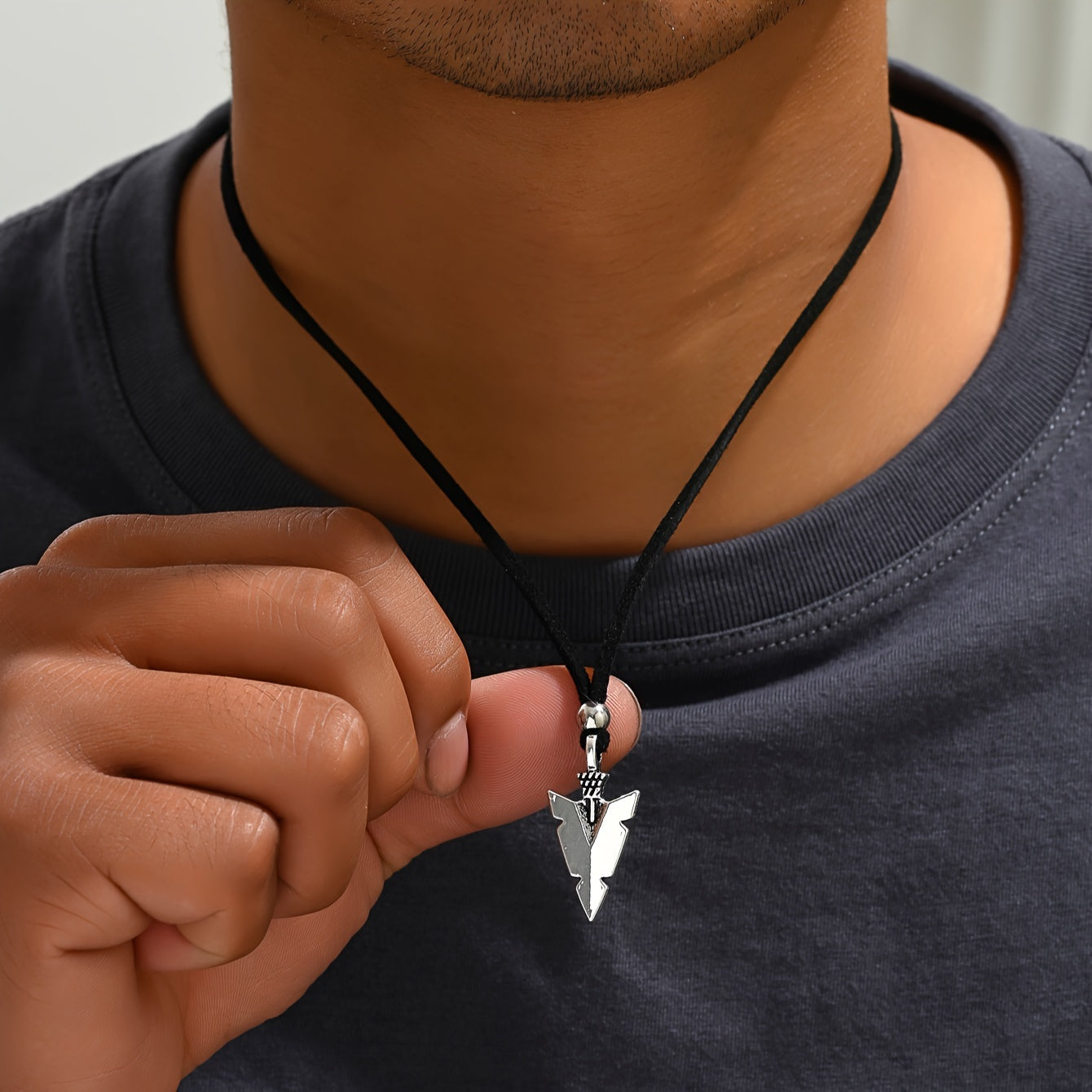 Men's casual accessories, a punk triangular arrow pendant, black rope necklace.