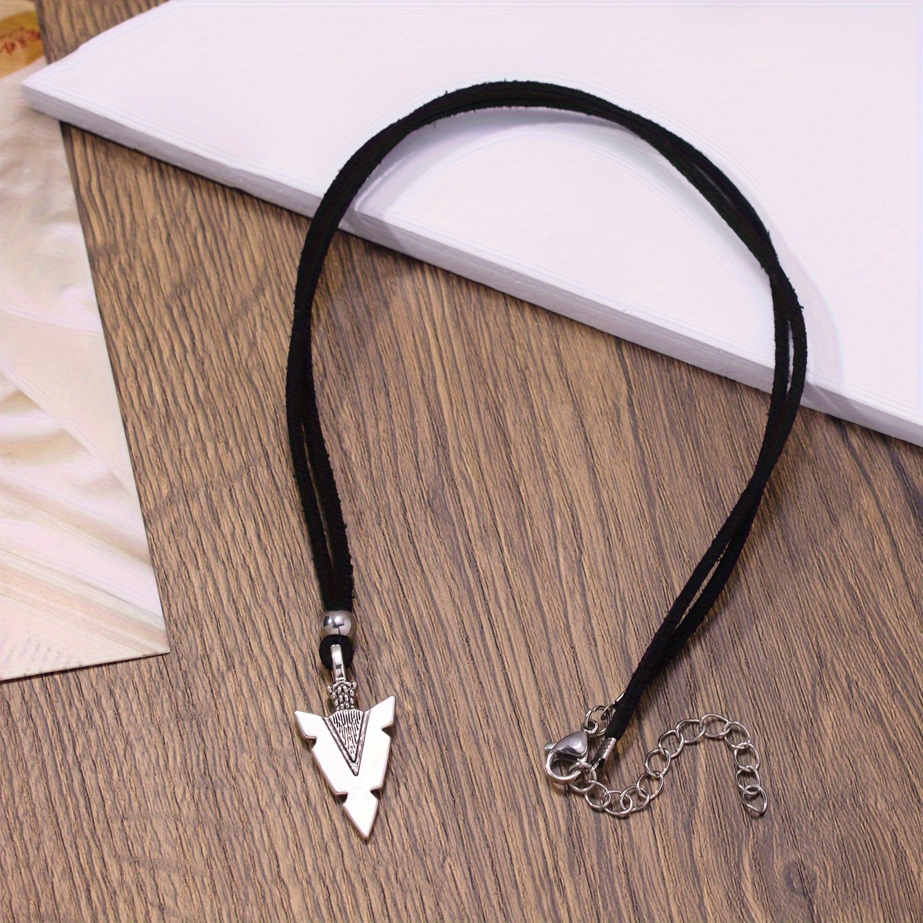 Men's casual accessories, a punk triangular arrow pendant, black rope necklace.