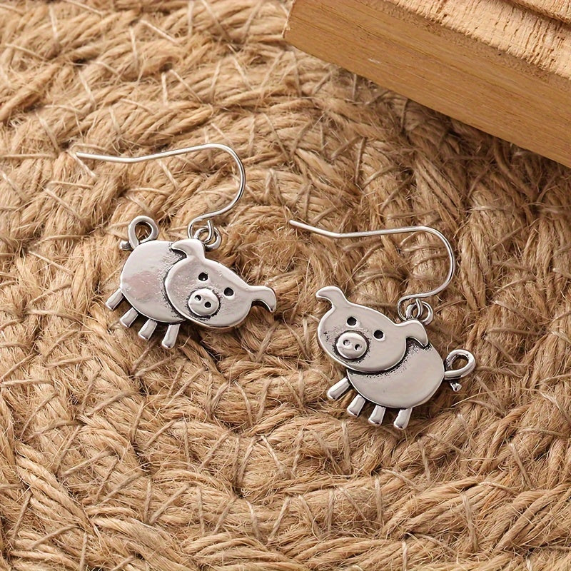 A pair of bohemian vintage pig-shaped pendant earrings, 925 silver-plated copper hooks, and charming animal jewelry for Casual Attire and gift giving, perfect for the Christmas season.