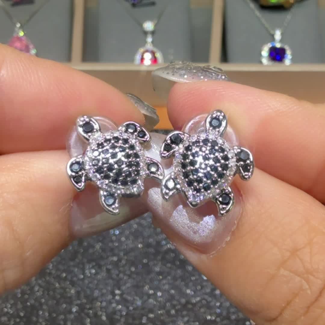 Elegant tortoise earrings adorned with black and white Zirconia, perfect for grand parties and events