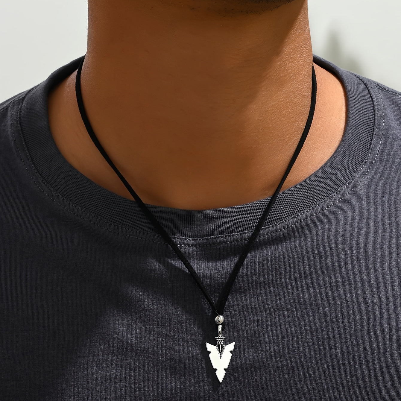 Men's casual accessories, a punk triangular arrow pendant, black rope necklace.