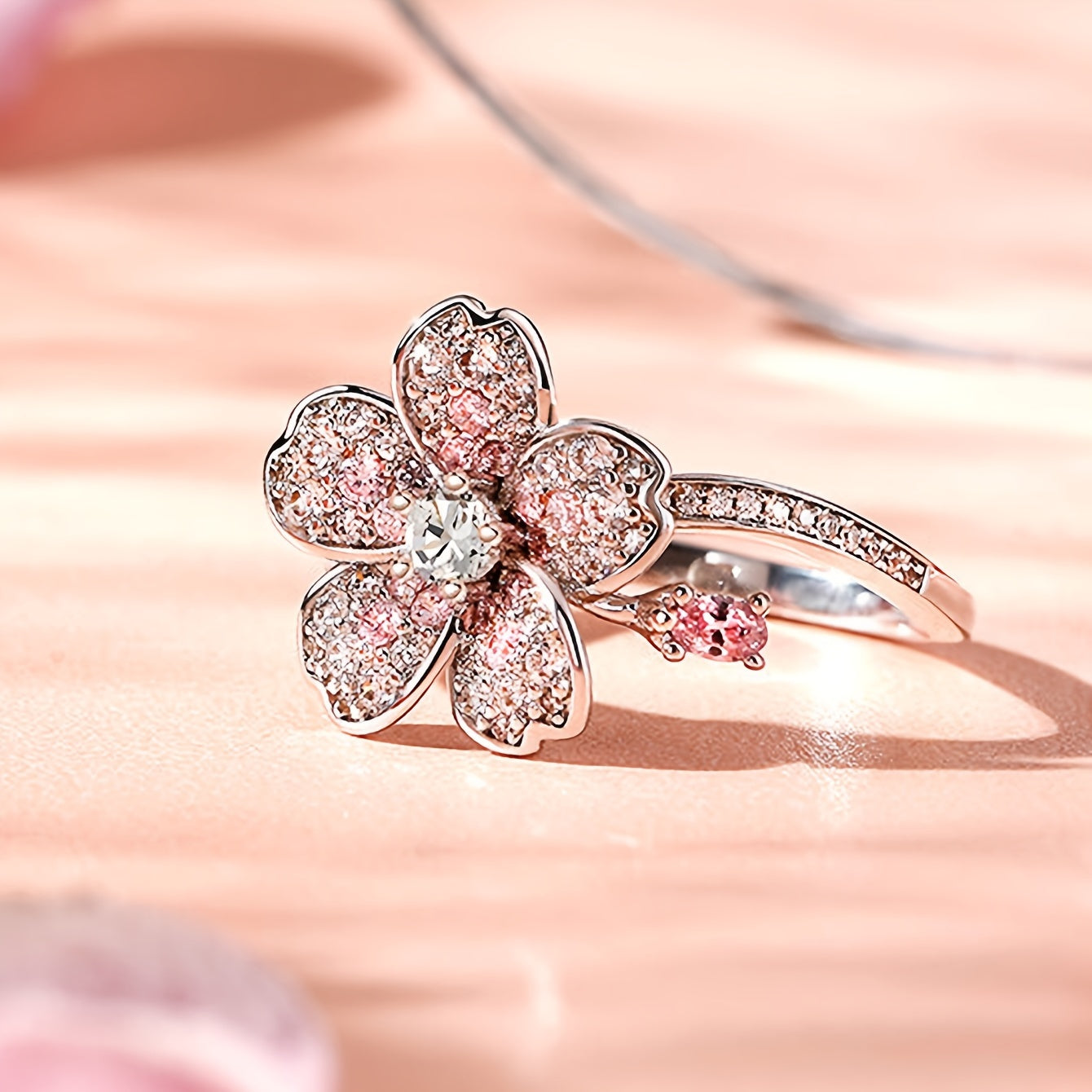 A ring of white Zirconia flowers and pink Zirconia rings. A lady's engagement ring for her Valentine's Day gift.
