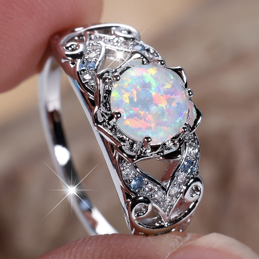 A delicate silver ring with synthetic opal and sapphire trim - perfect for parties and weddings