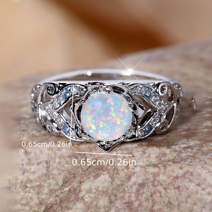 A delicate silver ring with synthetic opal and sapphire trim - perfect for parties and weddings