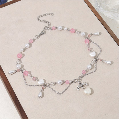 An elegant Y2K-style necklace with a butterfly bow and heart-shaped pendant, imitation pearl tassels, and cute fashion accessories for parties, birthdays, and holidays